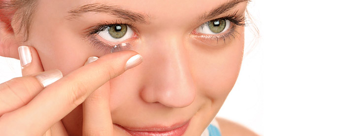 A woman putting in a contact lens