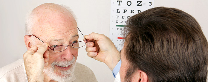 An older man being fitted with a new pair of glasses